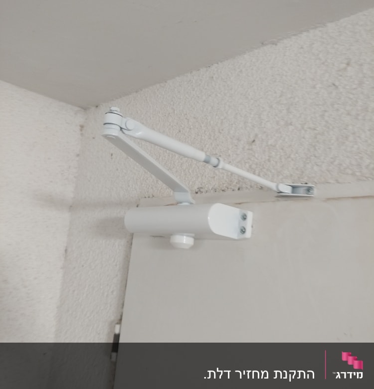 מנגנון סגירה אוטומטי לדלת מותקן על הקיר